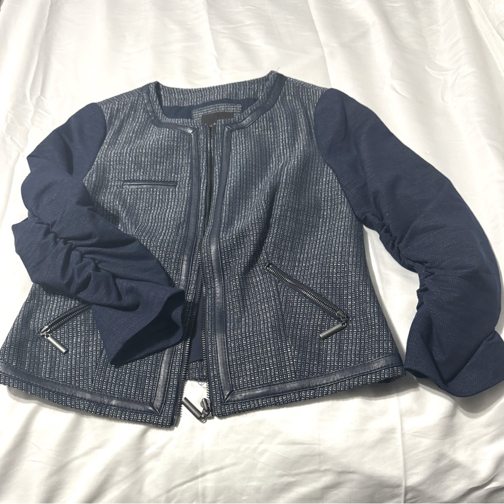 Navy blue jacket/  zipper on pockets.  Faux leather trim.  The ruched sleeves.